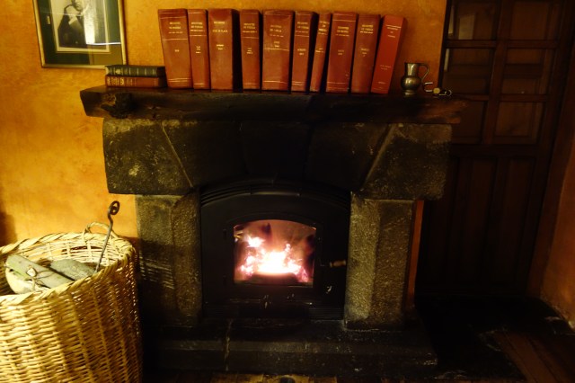 Fireplace in sitting room. Check out the old books on the top of the mantel. 